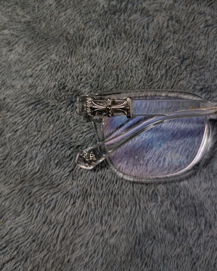 Eyeglasses with a decorative arm on a gray textured surface