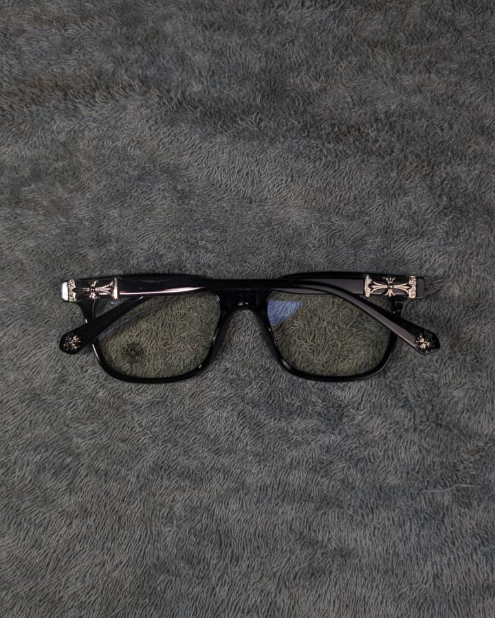 Black eyeglasses on a textured gray surface