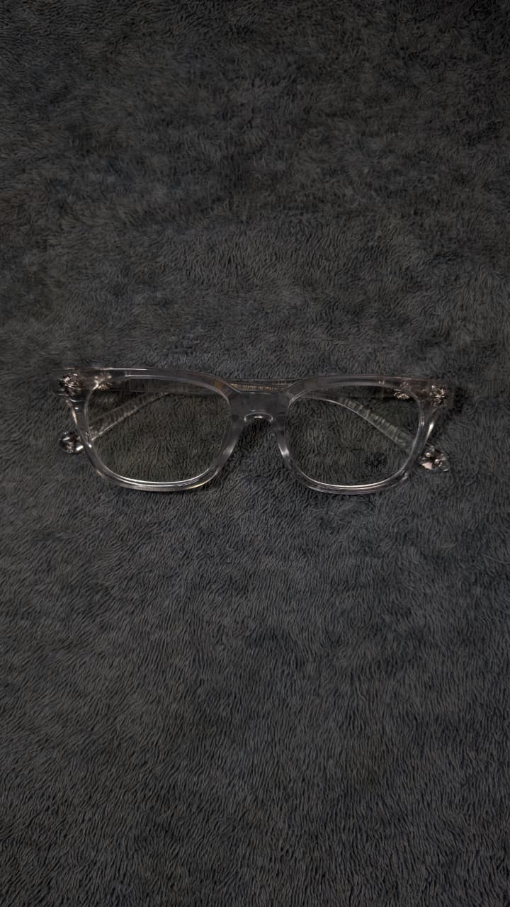 Pair of eyeglasses on a textured black surface