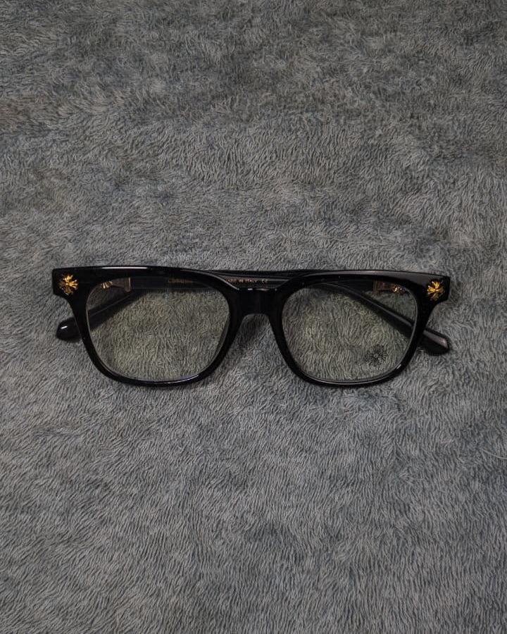 Black eyeglasses on a gray textured surface